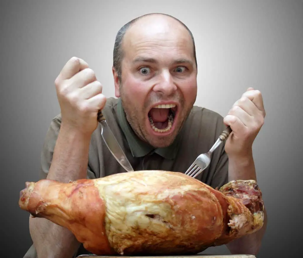 A meat crazed man appears to get ready to eat meat.